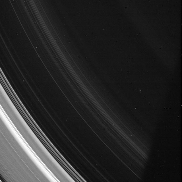 In this image from NASA Cassini spacecraft, the spiral structures in the D ring are on display, although it is so thin as to be barely noticeable compared to the rest of the ring system.