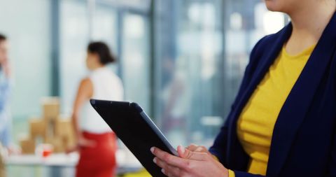 Casual Businesswoman Using Tablet in Modern Office Environment - Download Free Stock Images Pikwizard.com