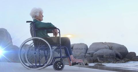 Senior Woman in Wheelchair Enjoying Tranquil Beach