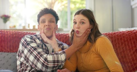Playful Couple Making Funny Faces on Sofa - Download Free Stock Images Pikwizard.com