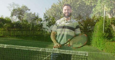 Smiling tennis player holding racket on grass court outdoors