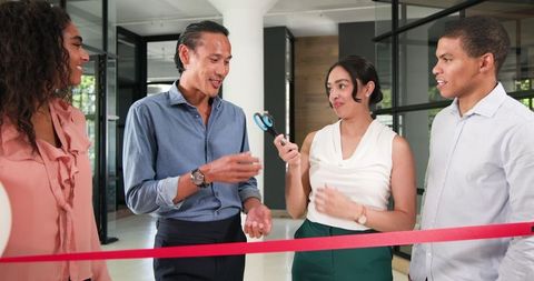 Ribbon cutting ceremony in office environment