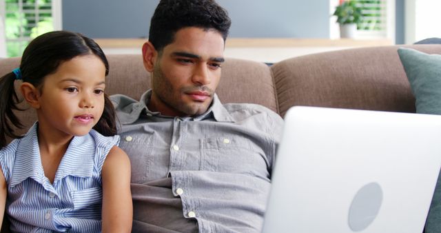 Father and Daughter Watching a Laptop Screen on Couch - Download Free Stock Images Pikwizard.com