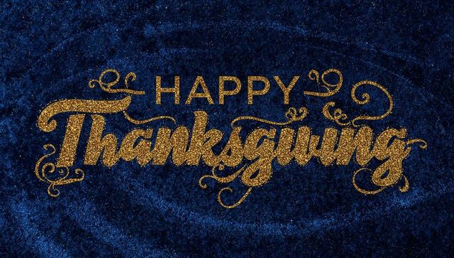 Gold glitter happy thanksgiving calligraphy on rich navy velvet texture for festive design