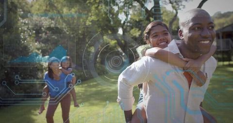 Smiling man carrying daughter piggyback on sunny backyard with hud overlay for family tech