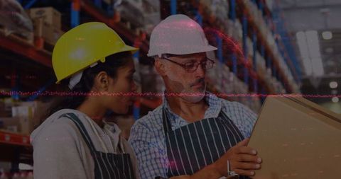 Diverse Warehouse Workers Analyzing Shipment Against Data Background