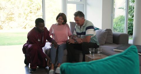 Senior Couple Receiving At-Home Care from Compassionate Caregiver