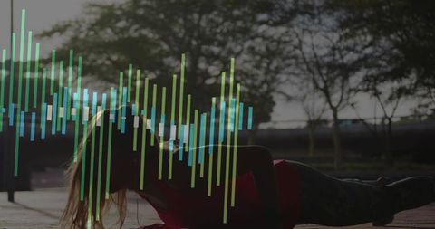 Holding plank at dusk with colorful audio waveform overlay for outdoor fitness branding