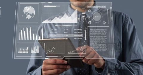 Man holding tablet tapping augmented reality dashboard with analytics and graphs