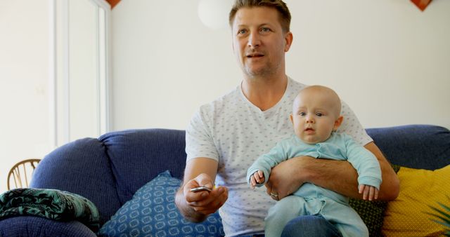 Father Bonding with Baby on Couch Watching TV - Download Free Stock Images Pikwizard.com