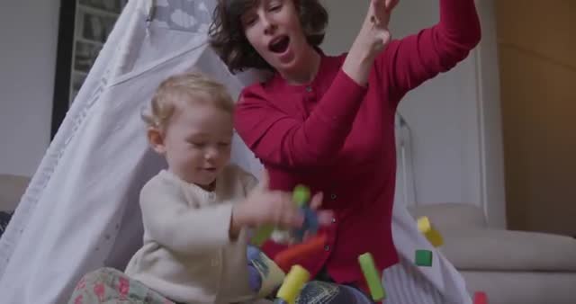 This video shows a joyful moment of a mother and her child playing with wooden blocks. The mother enthusiastically throws the blocks while the child engages with them, creating a lively and playful atmosphere. This video is perfect for family-oriented advertising, parenting blogs, educational content, and articles on child development.