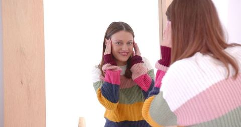 Smiling Woman in Colorful Sweater Enjoying Casual Self Care