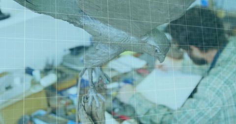 Artisan woodworker refining bird sculpture in workshop
