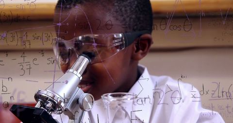 Curious Schoolboy Using Microscope with Mathematical Formulas Overlay - Download Free Stock Images Pikwizard.com