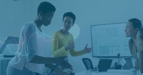 Women collaborating over blueprints in modern boardroom discussing project plans