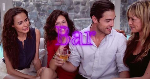 Friends Enjoying Drinks Seated Together in Bar