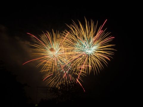 Colorful fireworks display over dark sky cover background