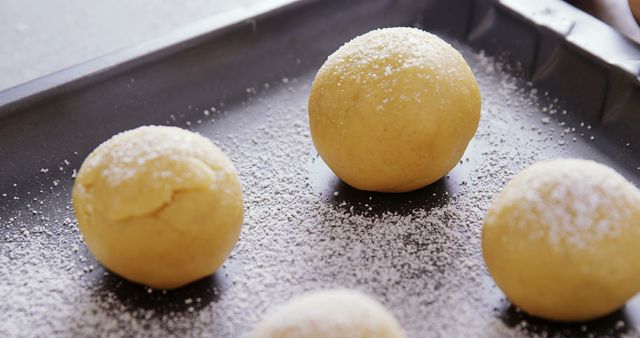 Close-up of Dough Balls Sprinkled with Flour on Baking Tray - Download Free Stock Images Pikwizard.com