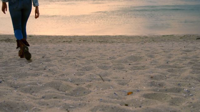 Scene captures a romantic proposal with a sandy beach setting, highlighting an intimate moment under serene dusk lighting reminding of coastal beauty. US flag overlay adds an element of patriotism or national pride. Ideal for illustrating themes of love, commitments, patriotic occasions, or advertising beach destinations or wedding services.