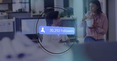 Diverse Coworkers Discussing Social Media Growth in Office