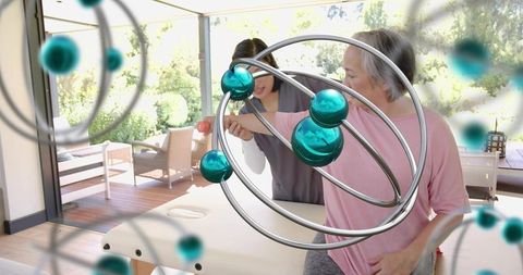 Caregiver guiding senior through ar-assisted rehabilitation on home therapy table