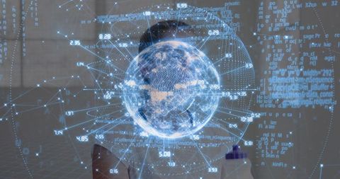 Female student pointing stylus at holographic globe of data and code in futuristic lab