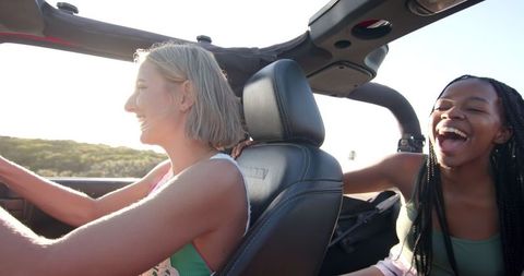 Joyful Friends on Summer Road Trip in Open-Top Car