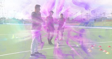 Field Hockey Coach Leading Youth Team Through Outdoor Drills on Turf with Violet Haze