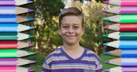 Smiling Child Surrounded by Vibrant Pencils Outdoors