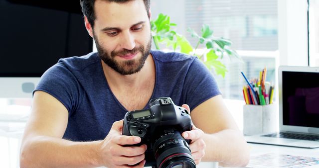 Photographer Reviewing Images on DSLR Camera in Office - Download Free Stock Images Pikwizard.com