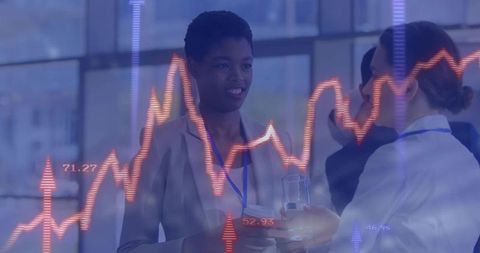 Businesswomen analyzing financial data with dynamic chart overlay