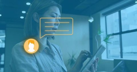 Woman tapping tablet in coworking lounge with digital chat interface overlay