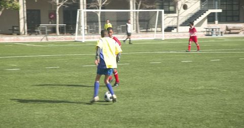 Youth Soccer Players Competing on Outdoor Field