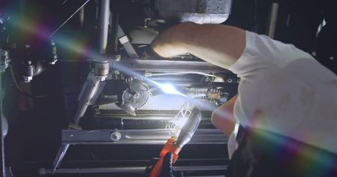 Technician welding machinery for industrial maintenance and repair