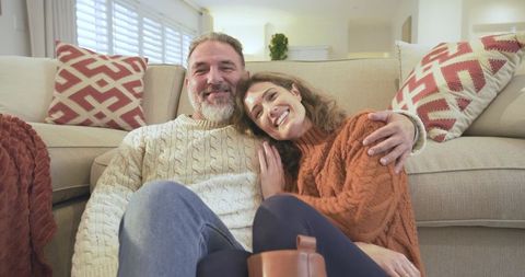 Couple Relaxing at Home in Warm Sweaters