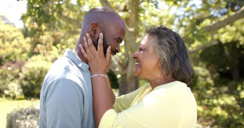 Joyful Senior Couple Embracing in Lush Outdoor Setting - Download Free Stock Images Pikwizard.com