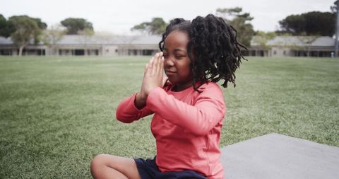 Child Practicing Meditation with Hands Folded Outdoors