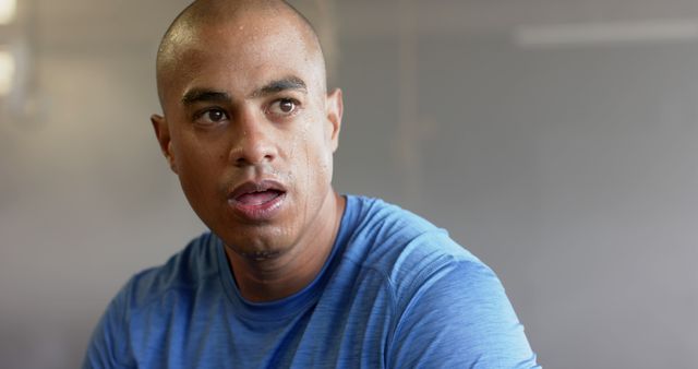 Focused Man in Blue Shirt after Intense Workout Session - Download Free Stock Images Pikwizard.com