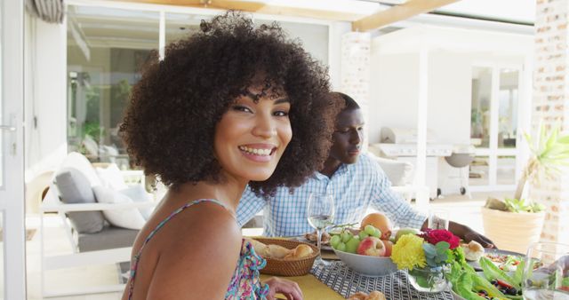 Happy woman enjoying outdoor meal with partner at home patio - Download Free Stock Images Pikwizard.com