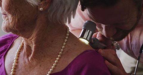 Senior woman undergoes dermatological examination at retirement home