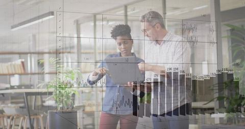 Colleagues Reviewing Data on Tablet in Modern Office with Transparent Charts Overlay for Analytics