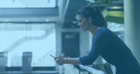 Woman engaged with smartphone in futuristic digital setting