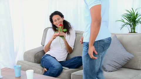 Romantic Gesture with Red Rose Bringing Joy at Home