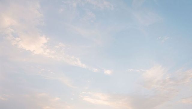 Pale Blue Sunrise Sky with Wispy Cirrus Clouds and Soft Pastel Light