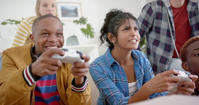 Diverse Group of Friends Smiling and Competing in Video Game - Download Free Stock Images Pikwizard.com