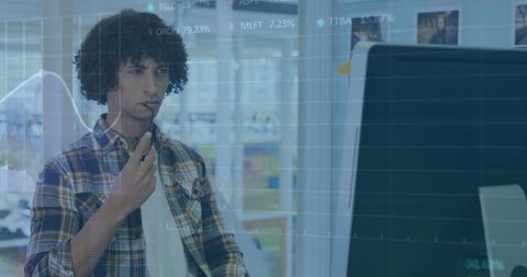 Businessman Analyzing Financial Data on Screen in Modern Office