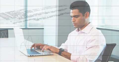 Professional Man Analyzing Financial Data on Laptop in Modern Office - Download Free Stock Images Pikwizard.com