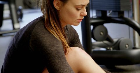 Focused woman preparing for workout in fitness studio