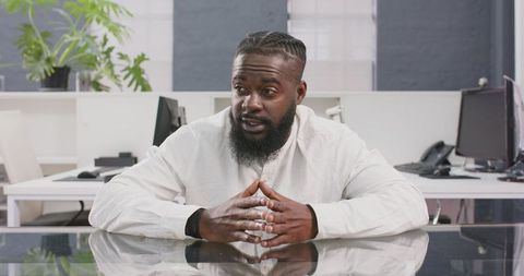 Confident businessman discussing strategies in modern office