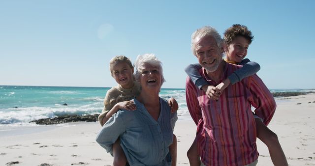 Happy Grandparents Piggybacking Grandchildren on Sunny Beach - Download Free Stock Images Pikwizard.com